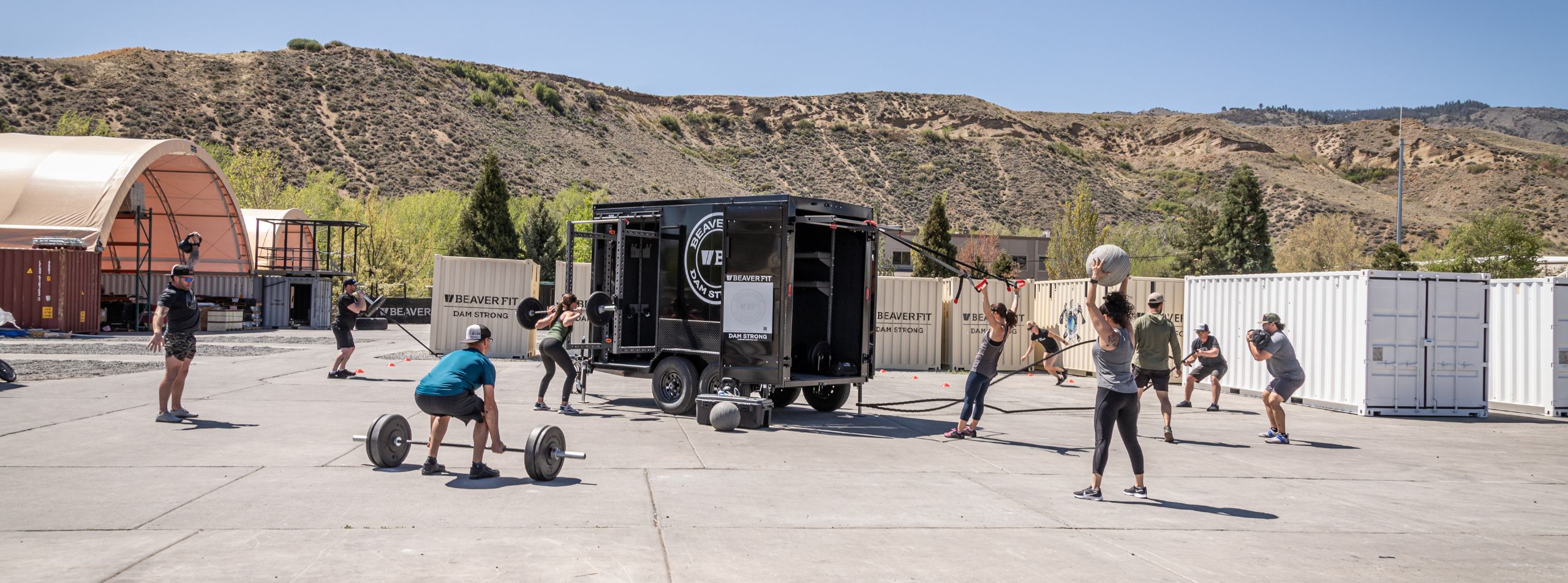 A group trains outdoors with a BeaverFit Beyond Trailer